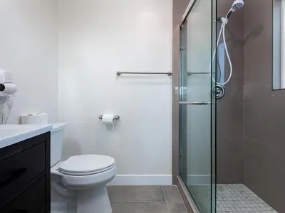 a bathroom with a toilet and a glass shower at Gated & remodeled 2b2b house 3373 in Baldwin Park