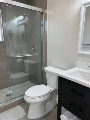 a bathroom with a shower and a toilet and a sink at Gated & remodeled 2b2b house 3373 in Baldwin Park