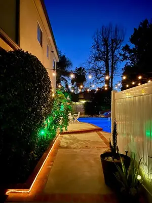 a backyard of a house with a pool at night at Cozy Guesthouse with Private Pool and Heated Jacuzzi in Santa Clarita