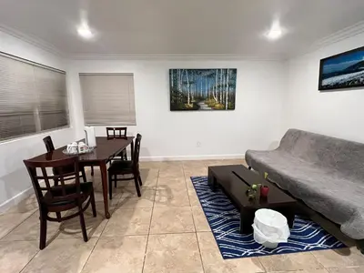 a living room with a couch and a table at Near Disney,college,sunset beach ,airport in Norwalk
