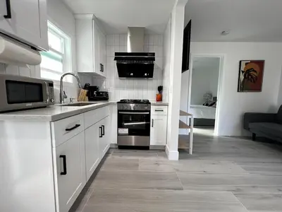 a kitchen with white cabinets and a stove top oven at Gated & Morden 1bed1bath house3367 in Baldwin Park