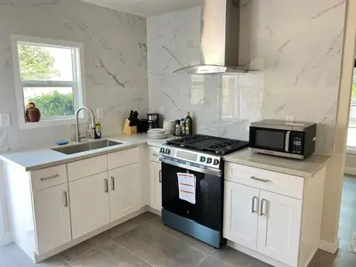 a kitchen with a stove and a microwave at Fully remoded 1B1B Home in baldwin Park3369A in Baldwin Park