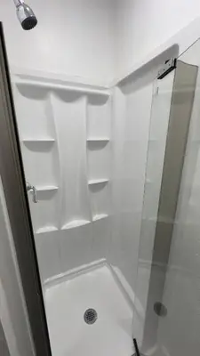 a bathroom with a shower with a glass door at Naryn Guest house in Los Angeles