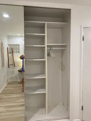 a closet with white shelves in a room at Manhattan Beach Beachfront Charming On The Strand in Manhattan Beach