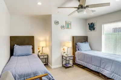 a bedroom with two beds and two lamps at 1 Mi to Rabobank Arena Home with Gazebo! in Bakersfield