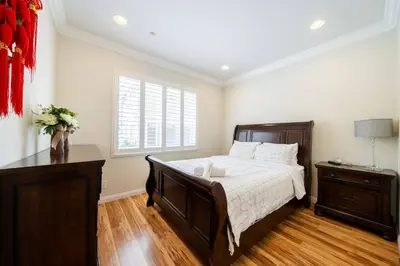 a bedroom with a large bed and a window at 40 ppl 2 houses 13 Bedrooms btw Disney Hollywd in Monterey Park