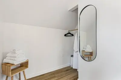 a room with a mirror and a table with towels at Midnight Chalet Big Bear Lake in Big Bear Lake