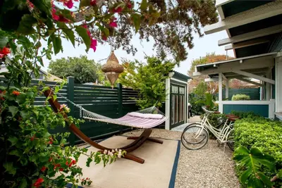 a hammock in a garden with a bike on a patio at Bougainvillea Bungalow Peaceful Venice Retreat in Los Angeles