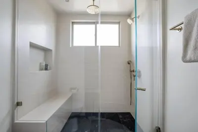 a bathroom with a shower and a glass shower stall at Pacific Breeze - Modern Venice Beach Home in Los Angeles