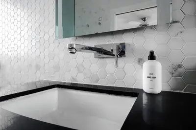 a bottle of soap sitting on a counter next to a sink at Venice Gem Private Beach Bungalow in Los Angeles