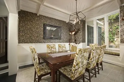 a dining room with a wooden table and chairs at Laurel Canyon Classic Hollywood Residence With Pool in Los Angeles