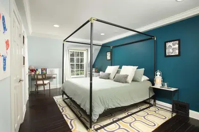 a bedroom with a bed with a blue wall at Laurel Canyon Classic Hollywood Residence With Pool in Los Angeles