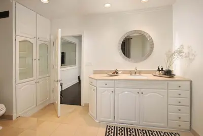 a white bathroom with a sink and a mirror at Laurel Canyon Classic Hollywood Residence With Pool in Los Angeles
