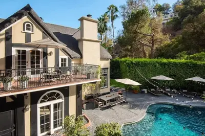 a house with a swimming pool in front of a house at Laurel Canyon Classic Hollywood Residence With Pool in Los Angeles