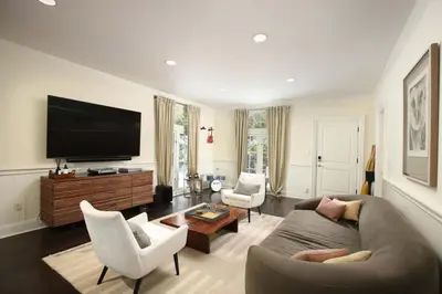 a living room with a couch and chairs and a flat screen tv at Laurel Canyon Classic Hollywood Residence With Pool in Los Angeles