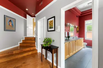 a home with red walls and a hallway with a sink at Oceanview Coastal Retreat in Redondo Beach in Redondo Beach