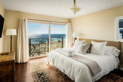 a bedroom with a bed with a view of the ocean at New Listing The Nautilus Manhattan Beachfront Retreat in Manhattan Beach