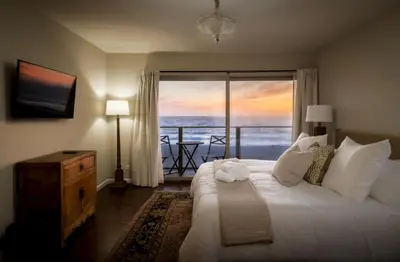a bedroom with a bed with a view of the ocean at New Listing The Nautilus Manhattan Beachfront Retreat in Manhattan Beach