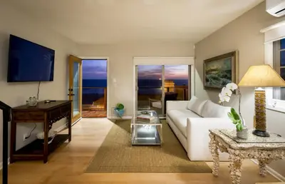 a living room with a white couch and a table at New Listing The Nautilus Manhattan Beachfront Retreat in Manhattan Beach