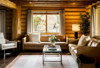 a living room with a couch and a table at Retreat to the Rocks Historic Film And Music Getaway in Chatsworth Lake Manor