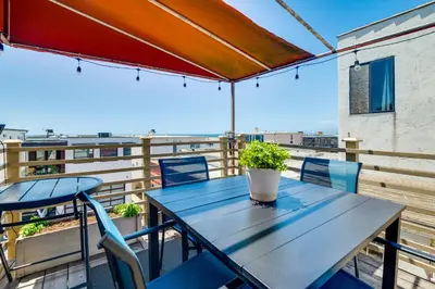 a table and chairs on a balcony with a view at Steps to Ocean Manhattan Beach Gem with Deck! in Manhattan Beach