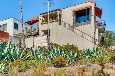 a house with people sitting on a balcony at Steps to Ocean Manhattan Beach Gem with Deck! in Manhattan Beach