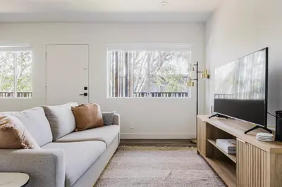 a living room with a couch and a flat screen tv at Blueground Mar Vista nr Venice Beach wd LAX-1327 in Los Angeles