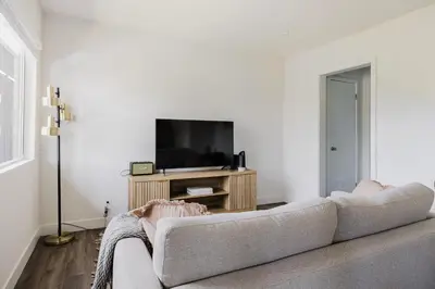 a living room with a couch and a flat screen tv at Blueground Mar Vista nr Venice Beach wd LAX-1327 in Los Angeles