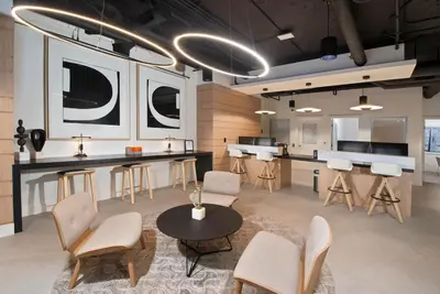 a room with a table and chairs and a kitchen at Blueground Venice pool wd nr beach LAX-1329 in Los Angeles