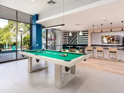 a living room with a pool table in it at Blueground Burbank pool bbq nr studios LAX-1321 in Los Angeles