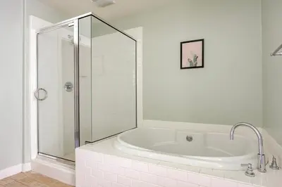 a white bathroom with a tub and a glass shower at Blueground Playa Vista pool AC nr beach LAX-1353 in Los Angeles