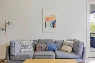 a living room with a gray couch with pillows at Blueground Playa Vista pool AC nr beach LAX-1353 in Los Angeles