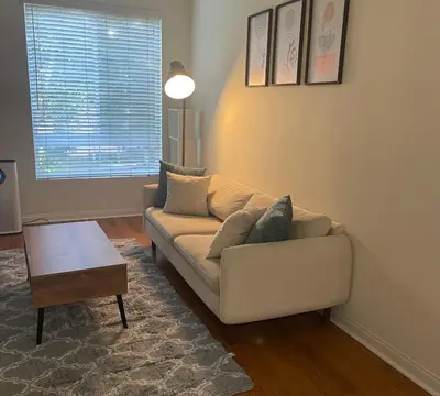 a living room with a couch and a table at LALAs House- 1br with Free Parking, Pool and Sauna in Los Angeles