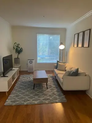 a living room with a couch and a tv at LALAs House- 1br with Free Parking, Pool and Sauna in Los Angeles