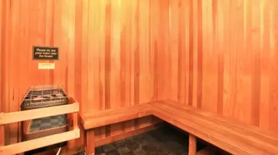 a wooden bench in a room with a sign on it at LALAs House- 1br with Free Parking, Pool and Sauna in Los Angeles