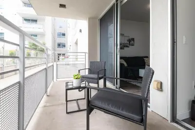 a balcony with a table and two chairs on it at Vista Point Suites in Los Angeles