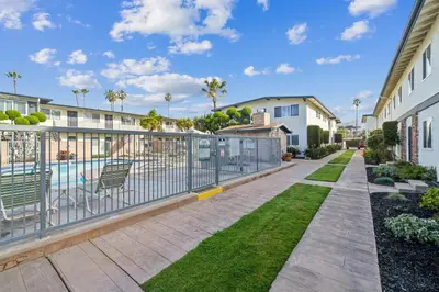 a balcony with a fence and a swimming pool at 4950 Sandyland Road #127 condo in Carpinteria