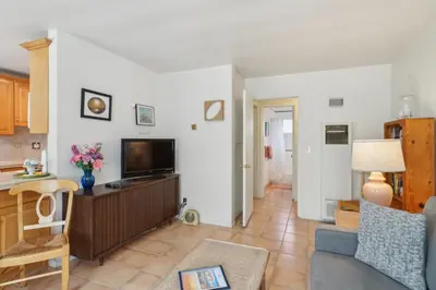 a living room with a tv and a couch at 4950 Sandyland Road #127 condo in Carpinteria