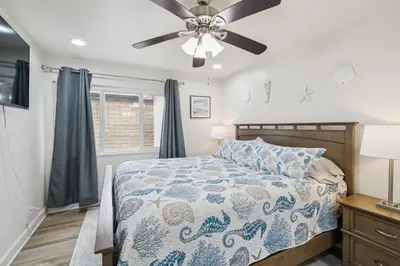 a bedroom with a bed and a ceiling fan at 2 Bed Beach Condo #125 in Carpinteria