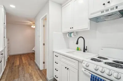 a white kitchen with a sink and a stove at Beach Condo with Private Patio #135 in Carpinteria