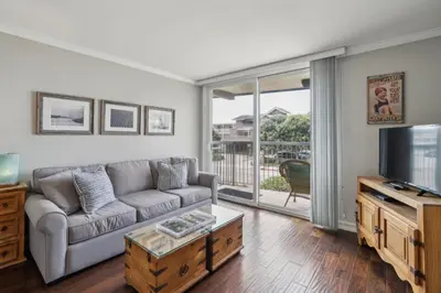 a living room with a couch and a tv at Beach Condo with Private Ocean View Balcony #237 in Carpinteria