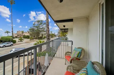 a balcony with chairs and a view of a street at Beach Condo with Private Ocean View Balcony #237 in Carpinteria