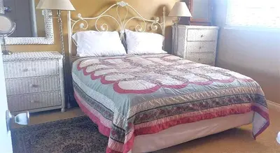 a bedroom with a bed with a quilt on it at Full 1 Bed Beach Condo #227 in Carpinteria