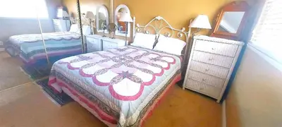 a bedroom with two beds and a dresser at Full 1 Bed Beach Condo #227 in Carpinteria