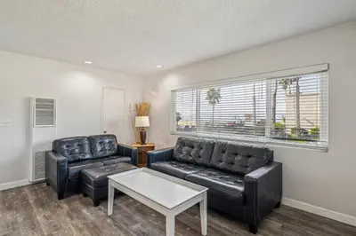 a living room with two leather chairs and a table at Beautiful 2 Bed Beach Condo #201 in Carpinteria