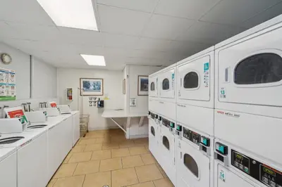 a laundry room with white washers and dryers at Beautiful 2 Bed Beach Condo #201 in Carpinteria