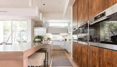 a kitchen with white cabinets and a large kitchen island at Stunning Home - Pool & Hot Tub - Fire Pit in Los Angeles