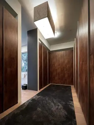 a hallway with wood paneling and a large rug at Stunning Home - Pool & Hot Tub - Fire Pit in Los Angeles