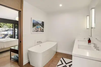 a white bathroom with a tub and a sink at Hollywood Hills Villa by Universal - Pool - Dogs OK in Los Angeles