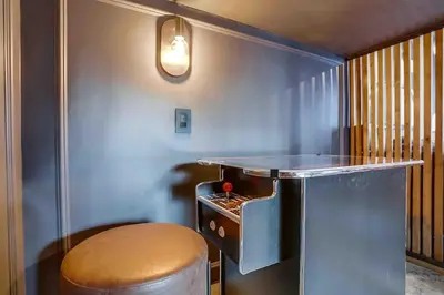 a bar with a stool and a counter in a room at Projector - Pool Table - 15min DT - Pets OK - BBQ in Los Angeles